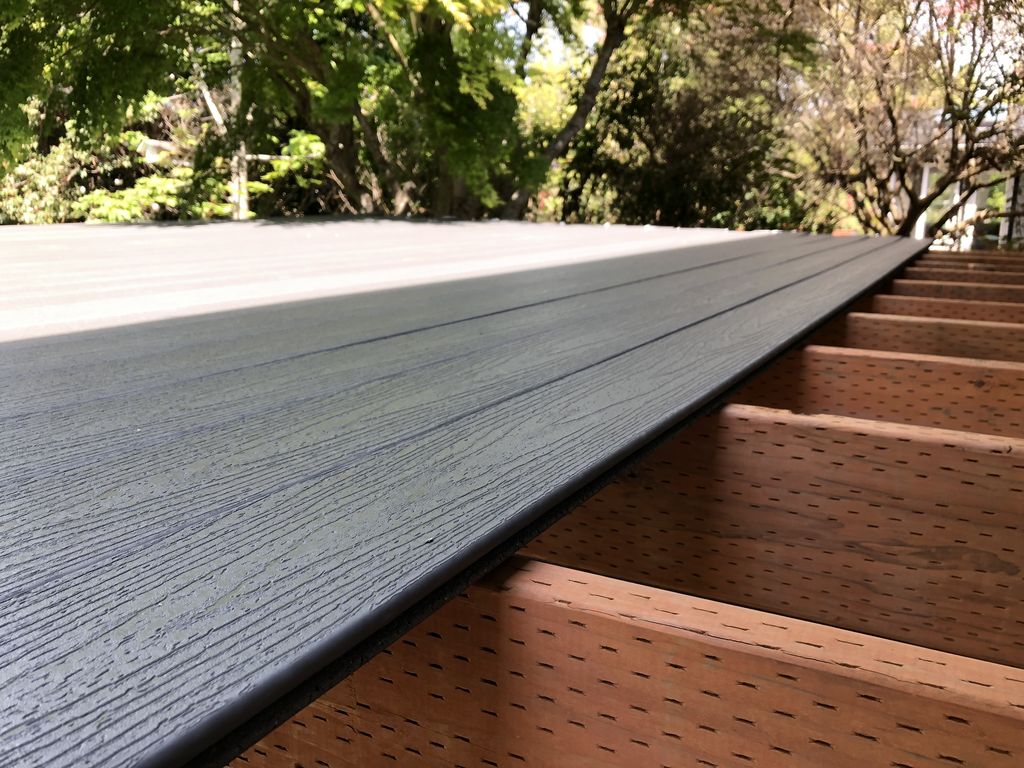 New composite deck boards installed over framing — close-up of a Fuego flooring swap