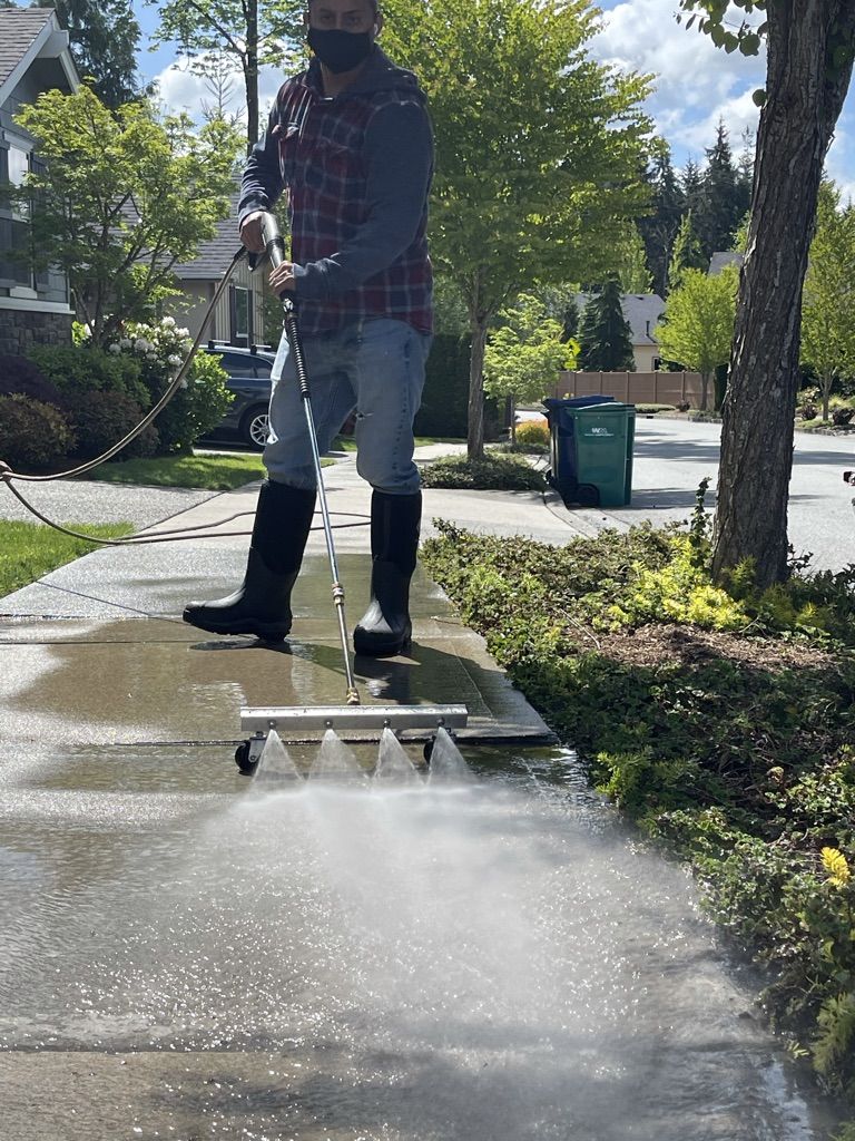 Fuego crew pressure-washing a driveway in a Snohomish County neighborhood